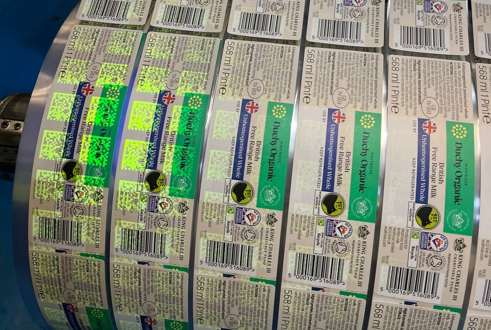 Milk labels on the press, their Invisible UV Tags glowing under UV light